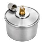Stainless steel spirit lamp lit with steady flame demonstrating burner operation on laboratory surface